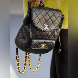 Fashion bag (small backpack) black leather with chains.